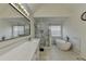 Bathroom featuring dual sink vanity, soaking tub, and tiled shower with bench at 2822 Savannah Walk Cv, Suwanee, GA 30024