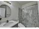 Stylish bathroom featuring a glass-enclosed shower with attractive marble tile and modern fixtures at 2822 Savannah Walk Cv, Suwanee, GA 30024