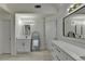 Spacious bathroom boasts dual vanity with quartz counters and separate doors to bath area at 2822 Savannah Walk Cv, Suwanee, GA 30024