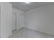 Bedroom with tiled flooring and closet doors, offering simple design at 2822 Savannah Walk Cv, Suwanee, GA 30024