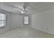 Bedroom featuring tiled flooring, a ceiling fan, and windows for natural light at 2822 Savannah Walk Cv, Suwanee, GA 30024