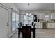 Bright dining room features wood floors, large windows and a modern chandelier at 2822 Savannah Walk Cv, Suwanee, GA 30024
