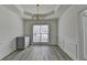 Elegant dining room with chandelier, wainscoting, and light wood flooring at 2822 Savannah Walk Cv, Suwanee, GA 30024