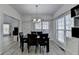 Bright dining room features wood floors and large windows looking into the living room at 2822 Savannah Walk Cv, Suwanee, GA 30024