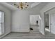 Classic dining room featuring wainscoting detail, modern light fixture, and neutral paint at 2822 Savannah Walk Cv, Suwanee, GA 30024