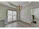 Charming dining room with a chandelier, wainscoting, and views of the foyer at 2822 Savannah Walk Cv, Suwanee, GA 30024