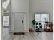 Bright foyer featuring soaring ceilings, light wood-look flooring and natural light at 2822 Savannah Walk Cv, Suwanee, GA 30024