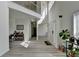 Expansive foyer boasting soaring ceilings, wood floors, and a view of the dining room at 2822 Savannah Walk Cv, Suwanee, GA 30024