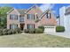 Charming brick front home with mature landscaping and a two-car garage at 2822 Savannah Walk Cv, Suwanee, GA 30024
