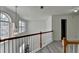Bright hallway features wood floors, natural light and staircase to upper level at 2822 Savannah Walk Cv, Suwanee, GA 30024
