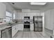 Bright kitchen features granite counters, white cabinets, and stainless steel appliances at 2822 Savannah Walk Cv, Suwanee, GA 30024