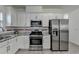 Bright kitchen features granite counters, white cabinets, and stainless steel appliances at 2822 Savannah Walk Cv, Suwanee, GA 30024
