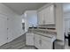 Bright kitchen features granite counters, white cabinets, and access to dining room at 2822 Savannah Walk Cv, Suwanee, GA 30024