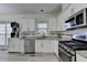 Bright kitchen features granite counters, white cabinets, and stainless steel appliances at 2822 Savannah Walk Cv, Suwanee, GA 30024