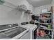 Functional laundry room features modern washer, dryer and shelving for storage at 2822 Savannah Walk Cv, Suwanee, GA 30024