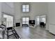 Open-concept living room with a soaring ceiling, fireplace, and plenty of natural light at 2822 Savannah Walk Cv, Suwanee, GA 30024