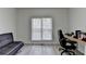 Bright office space with a large window, comfortable seating, and a functional desk area at 2822 Savannah Walk Cv, Suwanee, GA 30024
