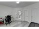 Office space showcasing double glass doors, and additional doorway with hardwood style floors at 2822 Savannah Walk Cv, Suwanee, GA 30024