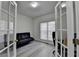 Inviting office space with french doors, a sofa, large window, and a desk at 2822 Savannah Walk Cv, Suwanee, GA 30024