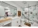 Bright bathroom features a marble tile shower, a sleek modern vanity and beautiful bronze hardware at 3011 Cravey Trl, Tucker, GA 30345