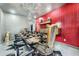Eclectic dining room featuring a unique table, statement chandelier, and bold red accent wall at 3011 Cravey Trl, Tucker, GA 30345