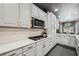 Close up on kitchen with white cabinets, quartz countertops, stainless steel appliances, and gas range at 3011 Cravey Trl, Tucker, GA 30345