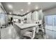 Open concept kitchen featuring white cabinets, quartz countertops, bar seating, and stainless appliances at 3011 Cravey Trl, Tucker, GA 30345