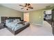 Spacious bedroom features a ceiling fan, neutral carpet and an ensuite bathroom providing space and privacy at 3011 Cravey Trl, Tucker, GA 30345