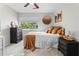 Cozy bedroom featuring a ceiling fan, a large window, neutral colors, and soft carpet at 3085 Balearic Se Dr, Marietta, GA 30067