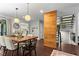 Bright dining room features a wooden table, modern light fixtures, and an open staircase at 3085 Balearic Se Dr, Marietta, GA 30067