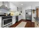Spacious kitchen boasts stainless steel appliances and sleek, white cabinetry at 3085 Balearic Se Dr, Marietta, GA 30067