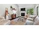 Inviting living room featuring a fireplace, a large window with wooded views, and modern decor at 3085 Balearic Se Dr, Marietta, GA 30067