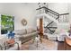 Bright, open-concept living room with high ceilings, a staircase, and large windows overlooking trees at 3085 Balearic Se Dr, Marietta, GA 30067
