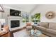 Cozy living room featuring a fireplace and large windows with tree-filled views at 3085 Balearic Se Dr, Marietta, GA 30067