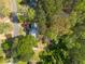 Overhead view of a house surrounded by lush trees, showcasing the home's location and neighborhood at 1800 East Gate Dr, Smoke Rise, GA 30087