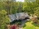 Beautifully landscaped two-story home with manicured lawns and a private driveway, nestled among mature trees at 1800 East Gate Dr, Smoke Rise, GA 30087