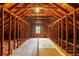 Spacious attic featuring exposed wooden beams, flooring and a bright window for potential conversion or storage at 1800 East Gate Dr, Smoke Rise, GA 30087