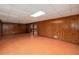 Unfinished basement featuring wood paneling, tile floor, and an open layout, great for storage or renovation at 1800 East Gate Dr, Smoke Rise, GA 30087