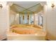 Bathroom features a luxurious jacuzzi tub with unique mirrors and decorative lighting, perfect for relaxation at 1800 East Gate Dr, Smoke Rise, GA 30087