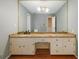 Bright bathroom with a large vanity, granite countertop, and ample storage, offering both functionality and style at 1800 East Gate Dr, Smoke Rise, GA 30087