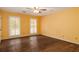 A sunlit bedroom has hardwood floors and window shutters, creating a warm and inviting atmosphere at 1800 East Gate Dr, Smoke Rise, GA 30087