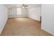 A spacious bonus room features neutral carpet, a ceiling fan, and built-in shelves for storage and organization at 1800 East Gate Dr, Smoke Rise, GA 30087