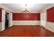 Dining room with hardwood floors, a chandelier, and stylish red and white color scheme at 1800 East Gate Dr, Smoke Rise, GA 30087