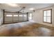 Spacious garage with an automatic door and natural light, offering ample space for vehicles and storage at 1800 East Gate Dr, Smoke Rise, GA 30087