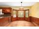 Cozy kitchen area with wood cabinets, bay windows, and hardwood floors, ideal for morning light at 1800 East Gate Dr, Smoke Rise, GA 30087