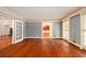 Large living room with hardwood floors and white trim, perfect for gatherings and entertainment at 1800 East Gate Dr, Smoke Rise, GA 30087