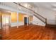 Bright living room with hardwood floors, a staircase, and access to other areas of the house at 1800 East Gate Dr, Smoke Rise, GA 30087