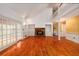 Bright living room with hardwood floors, fireplace, and large windows, perfect for entertaining at 1800 East Gate Dr, Smoke Rise, GA 30087