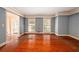 Large living room with hardwood floors and neutral paint, awaiting your personal touch at 1800 East Gate Dr, Smoke Rise, GA 30087