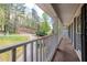 A peaceful covered porch offers scenic views of the landscaped yard and surrounding greenery at 1800 East Gate Dr, Smoke Rise, GA 30087
